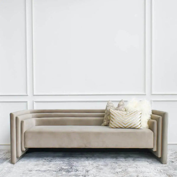 The light bronze hue of the Haus sofa  perfectly matches the grey hues of the Levine rug, for a modern art rug design.