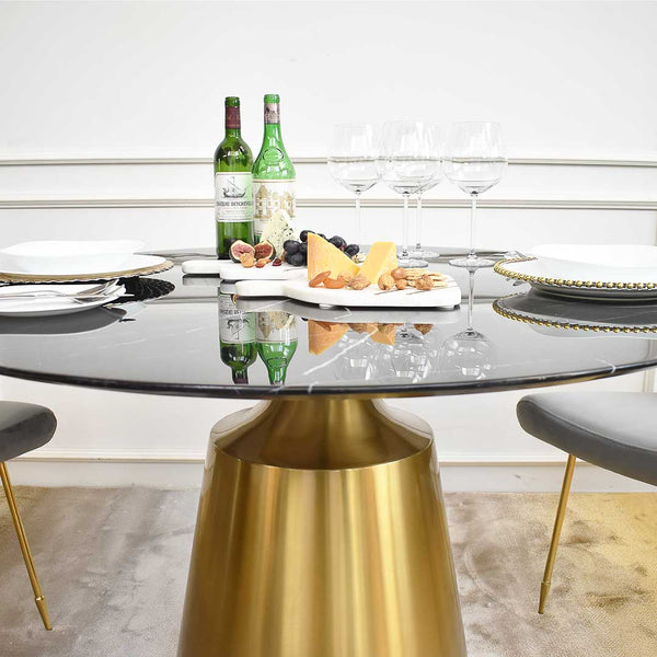 Stainless steel brushed gold base underneath Emma dining table, slim marquina marble table top. 