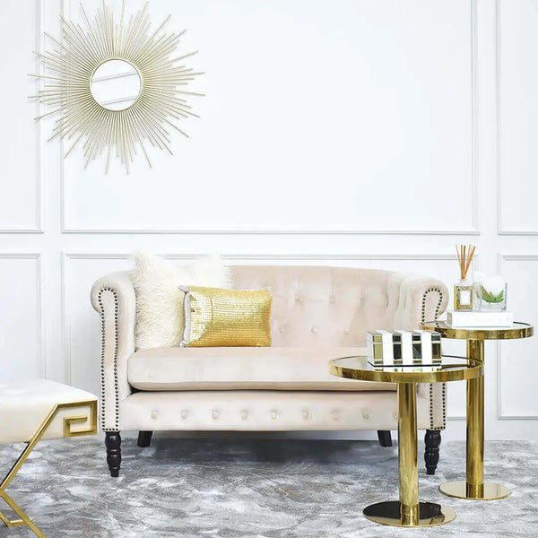 Modern Luxury Living Room Design Ideas with Fayette 2-seater Sofa, Gold Round Side Tables and Treves Luxury Rug with Sunburst Wall Art Displayed with White and Gold Decor Items at Furniture Showroom.