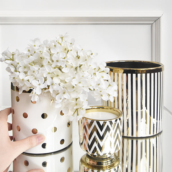 Plant pots in gold and white polka dot and striped details.