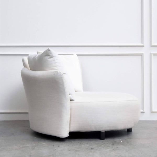 Side angle of the Paramour Sofa highlighting the smooth curve of the backrest and the elegant gen-metal
finish
 legs.