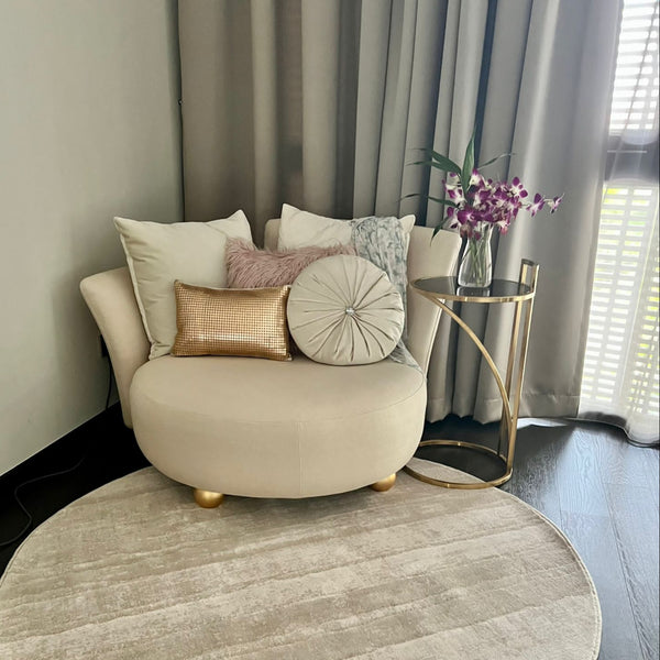 Cream leatherette Paramour Sofa in a modern living room, paired with a round Pruie C-shaped table ,plush throw pillows and a luxury round rug from FinnAvenue.
