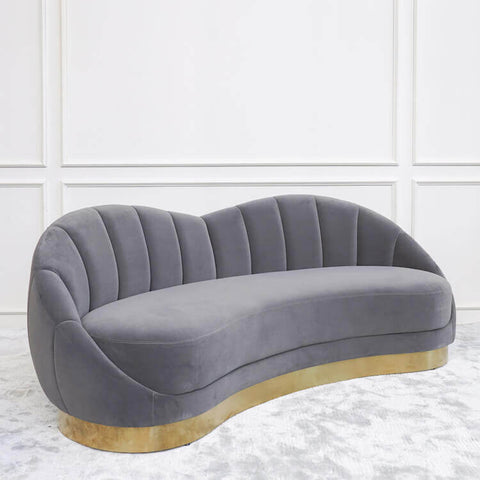 Primrose Art Deco Curved Sofa in Lush Grey Velvet with Gold Base in a luxurious Singapore living room.