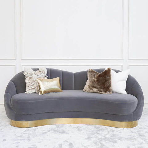 Primrose Curved sofa in a smooth lush velvet Grey, curving and swooping back rest that envelopes you in the sofa seats for a comfortable home experience.