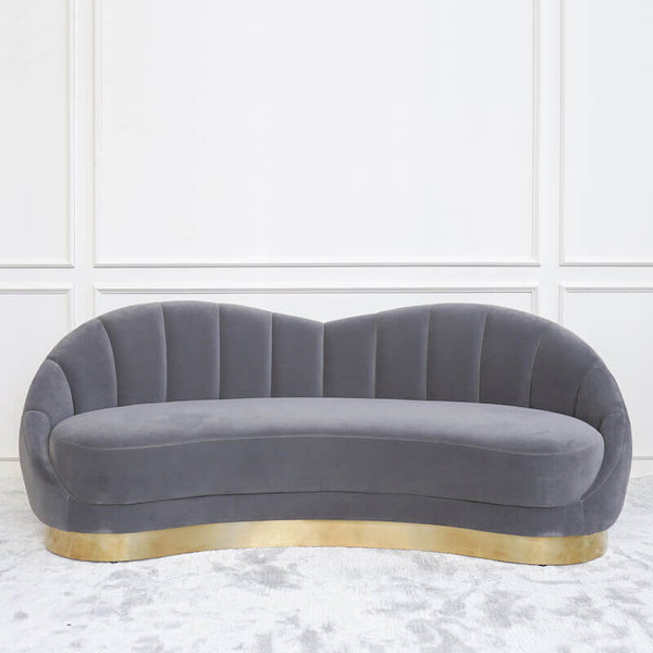 Channel an old Hollywood glam vibe with the Primrose curved grey sofa set, with luxurious velvet upholstery and gold base.