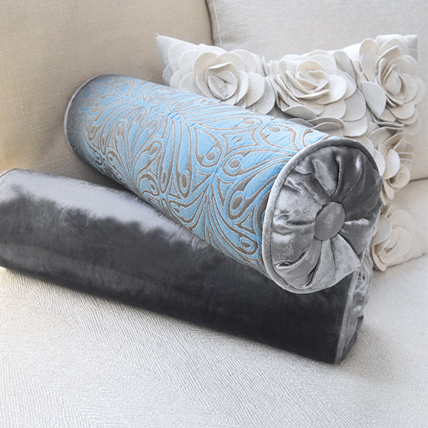 Otis rolled pillow, light blue floral motifs on soft grey velvet satin.