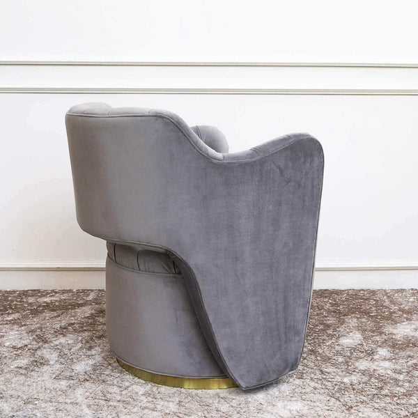Back view of the Raphael Grey tufted swivel armchair with sleek curves.