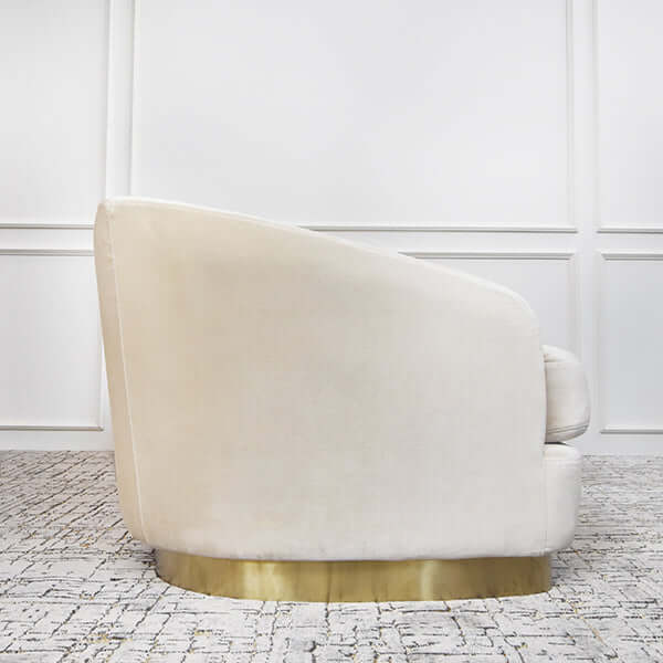 Sculptural curved sofa with recessed gold pedestal base and undulating armrests.