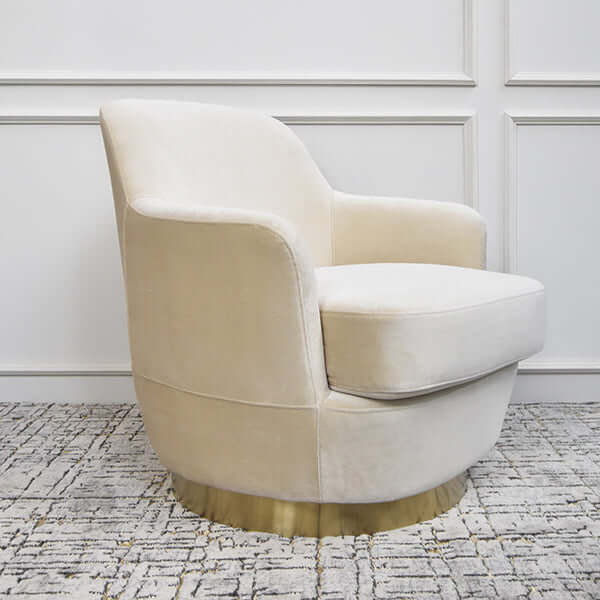 Side view of the Rever Armchair in velvet, showcasing its gently curved backrest and modern sculptural silhouette.