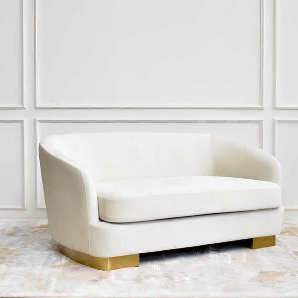 Angled side view of the Rever 2 seater sofa, petite and curved, making it the perfect size for a bedroom sofa. 