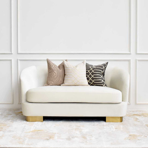 Curved high back rest that tapers down at the armrest, mix and match bold cushions for a pop of colour.