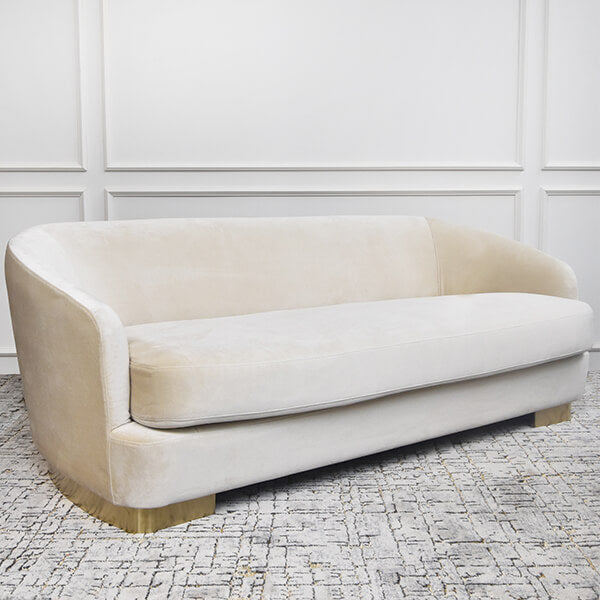 Side angle of the modern curved Rever sofa, brushed stainless steel legs. 