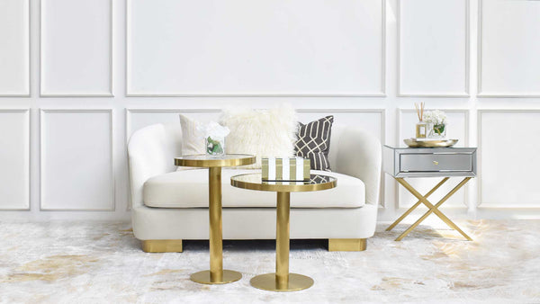 Rever 2-Seater Sofa styled in a living room setting with custom throw pillows, luxurious upholstery, and mid-century modern curves.