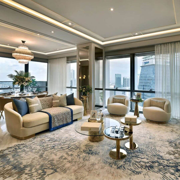 A stunning living area in a Wallich Residence luxury showflat featuring the elegant Rever Sofa, two Infiniti swivel armchairs, and stylish Vis-a-vis Coffee Tables, showcasing affordable luxury design and high-end comfort. Designed by Cynosure Design.