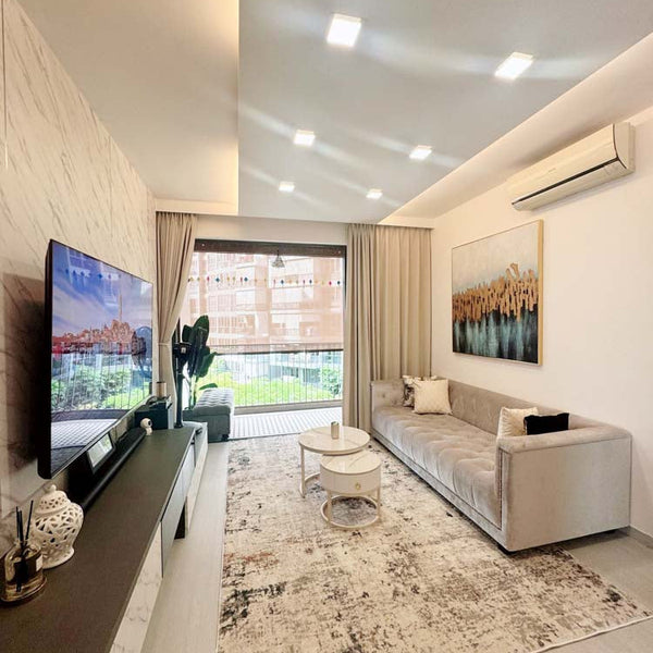 The classic Earl Chesterfield Sofa in plush grey velvet provides affordable luxury and is the perfect centerpiece for a modern condo living room.