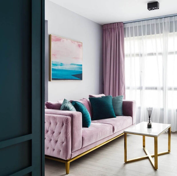 Custom mauve velvet Fitzgerald sofa in teal and mauve-themed living room with matching curtains and artwork.