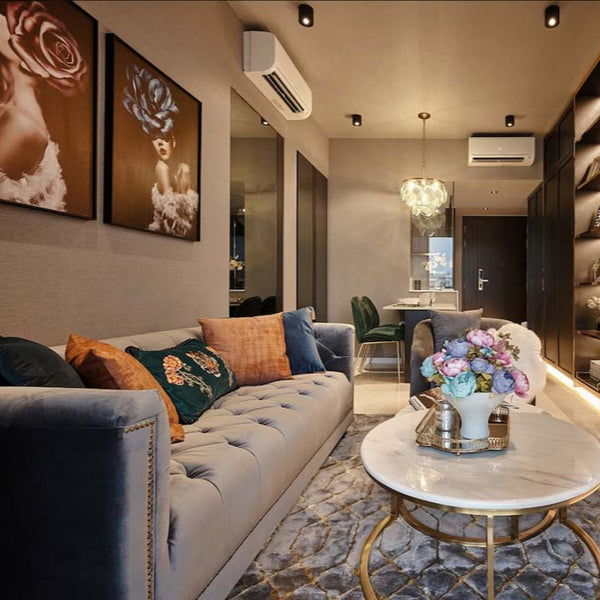 The classic Earl Chesterfield Sofa in plush grey velvet provides affordable luxury in this stunning condo, expertly designed by Singapore's Mr Shopper Studio.