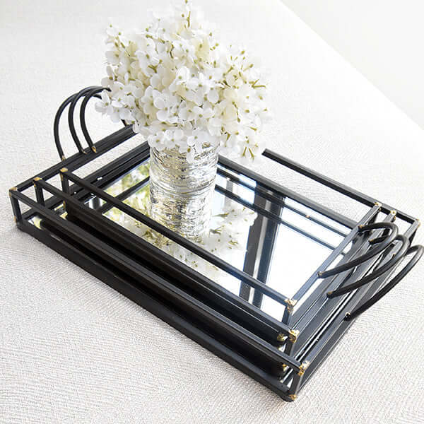 Cream hydrangea in a glass vase on a stacked mirrored tray.