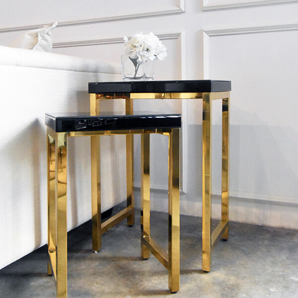 Side view of the Thierry night stand, black glass top and polished shiny gold legs.