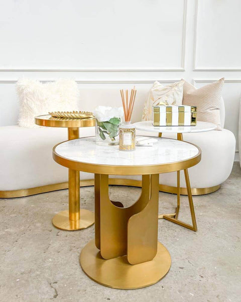 Statuesque and stylish, this tall Vis-a-vis-II Polished Gold Side Table pays homage to modern sculpture and art. Inspired by the ever-so-popular Modern Art Deco Design, this petite end table is perfect for a living room coffee table that is small yet stylish and grand.