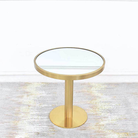 Vis-a-vis Round Coffee Table (grande) with mirrored table top inset table rim using stainless steel plated in brushed gold. Table sits atop a round pedestal and tube gold round base for a vintage yet timeless feel.