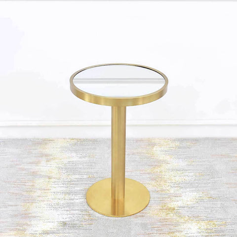 Vis-a-vis Round Gold Petite Side Table sits on a pedestal round gold base for a luxurious small living room. Small round mirrored table top is inset brushed gold rim in stainless steel.