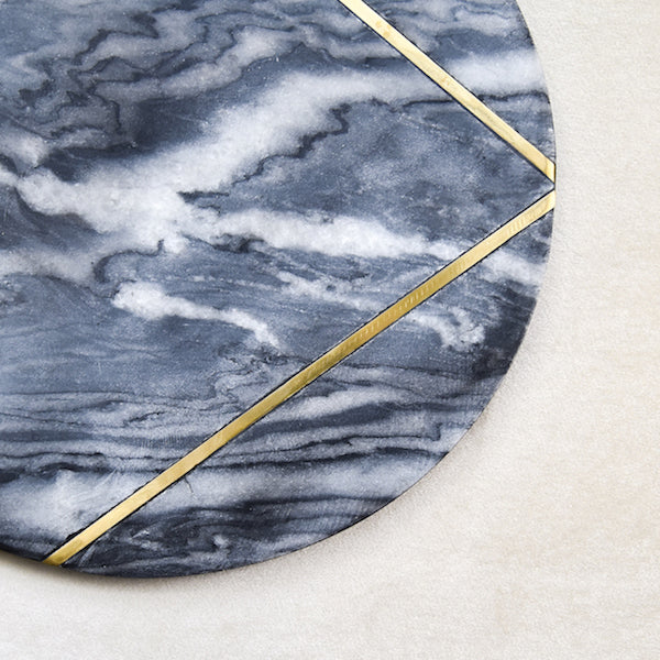 Close up look of the marbled grey patterns and swirls, with the brass inlaid details.
