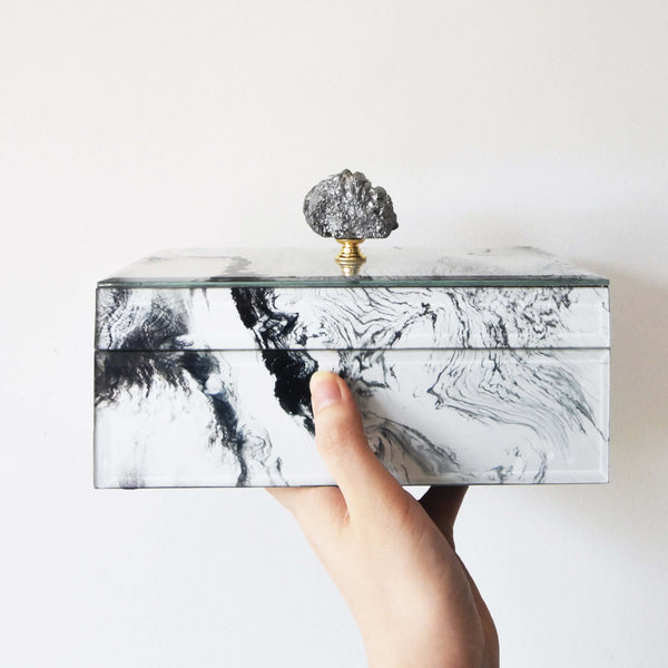 Hand holding the Zeus box.