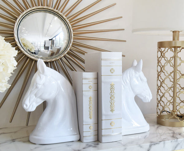 Designer table top display of white leather books and white bookends.