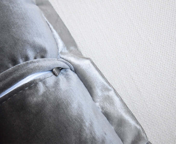 Zoomed in details of the Grey silver flanged cushion back zipper.