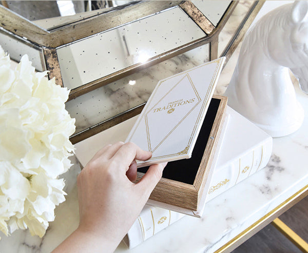 Home decor ideas come alive with white faux leather wooden Book Box on white marble table.
