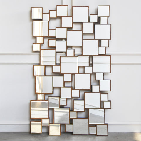 Geometric paradox is a large wall mirror with geometric cubes on hand carved solid wood frame.