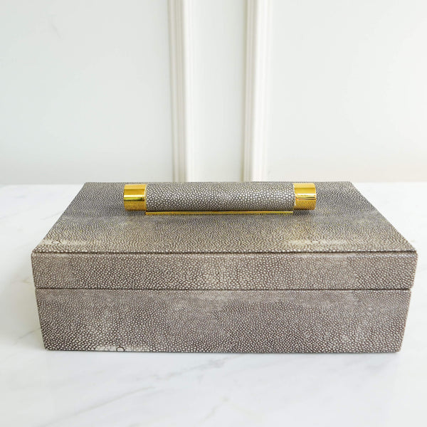 Alcott Trinket box with faux snake skin leather and polished gold steel trimmings on handle top .
