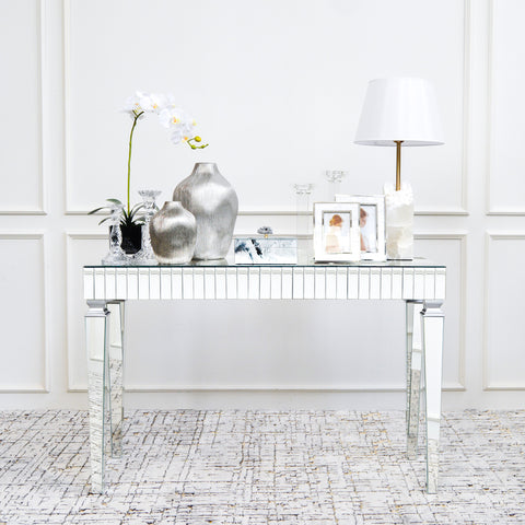 Channel your inner elegance with the Angelica Mirrored Console Table, not forgetting the decor pieces on top.