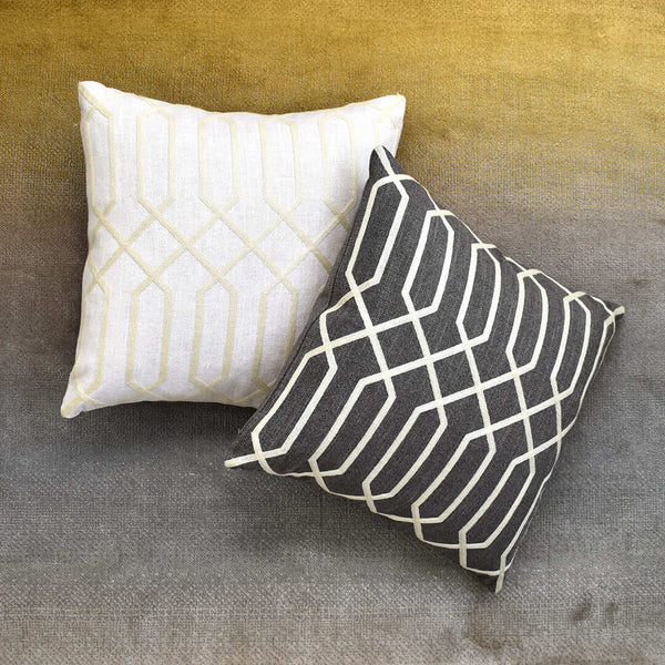 Top view of linen square cushions with timeless modern geometric embroidery. 
