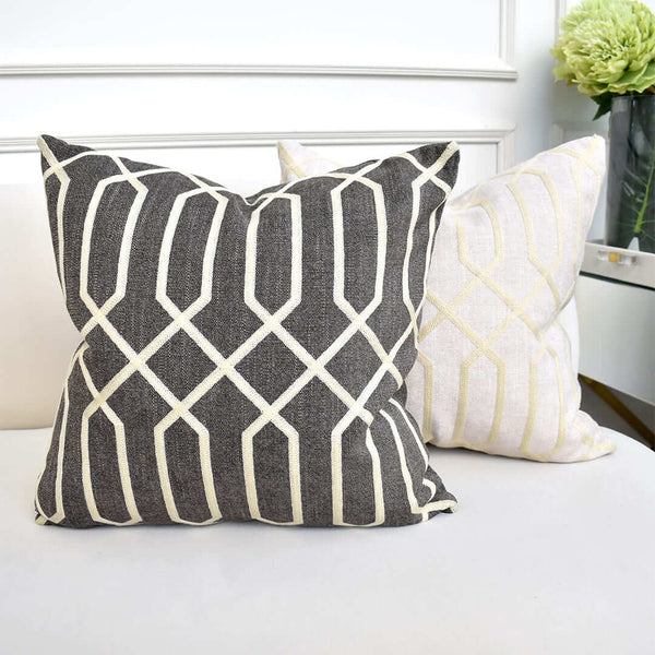 Atticus Embroidery Square Cushion, Linen Gold Grey and Gold Beige sitting on sofa seat.