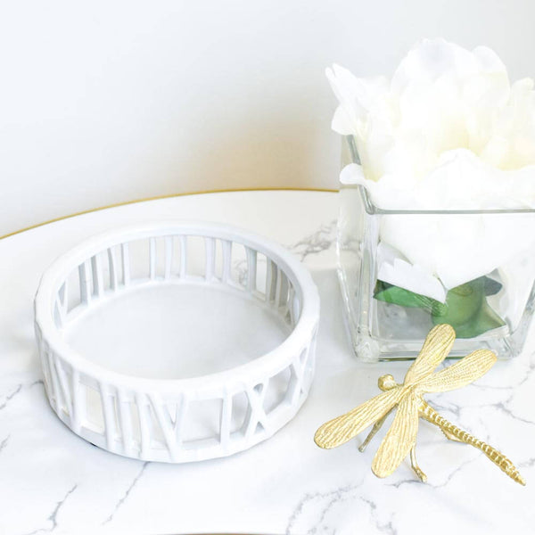 Round white ceramic tray with roman numeral on sides.