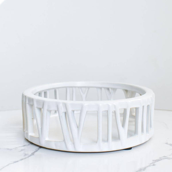 Side view of white ceramic tray round with roman numerals.