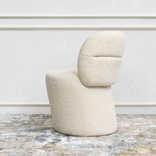 This statement accent chair, which is crafted with a hardwood frame, features an inviting silhouette with soft fluffiness mixed with natural textured upholstery that calls on fun and liveliness of a bright spacious home.