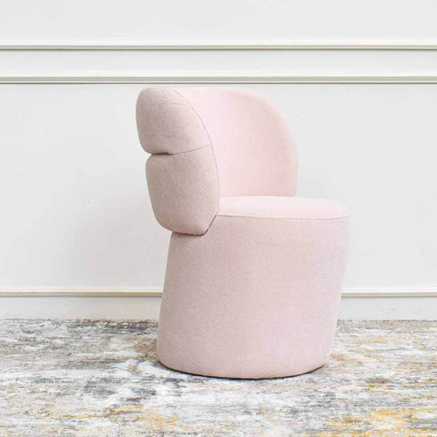 Pink accent chair with boucle fabric.
