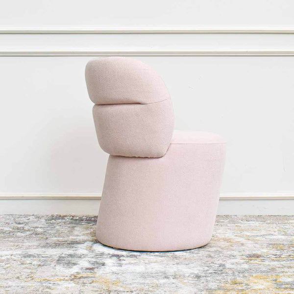 Side view of Bonbon Accent Chair in Boucle Blush Pink, showcasing the side curves of the chair.