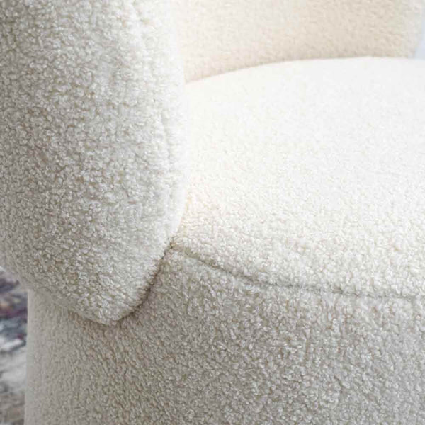 Zoomed in image of how boucle fabric looks like, it is made up of a series of looped fabric to create a soft fluffy texture on the Bonbon accent chair.