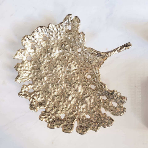 Gold textured sculpture tray crafted in gold metal.