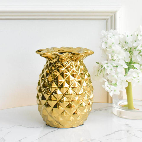 Chanceux gold pineapple jar is a gold textured ceramic decor piece. Place as a display on your coffee table.