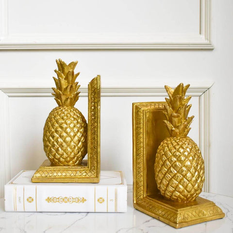 Chanceux Pineapple Gold Bookends, Sculpture Decor. Gold textured bookends perfect for use as a display on console table or as a bookend for letters and books.