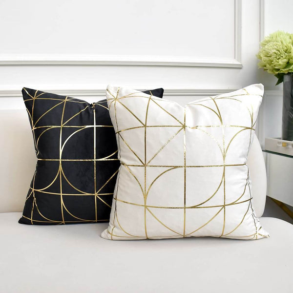 Art deco cushion with geometric lines in ivory or black velvet with gold details. 