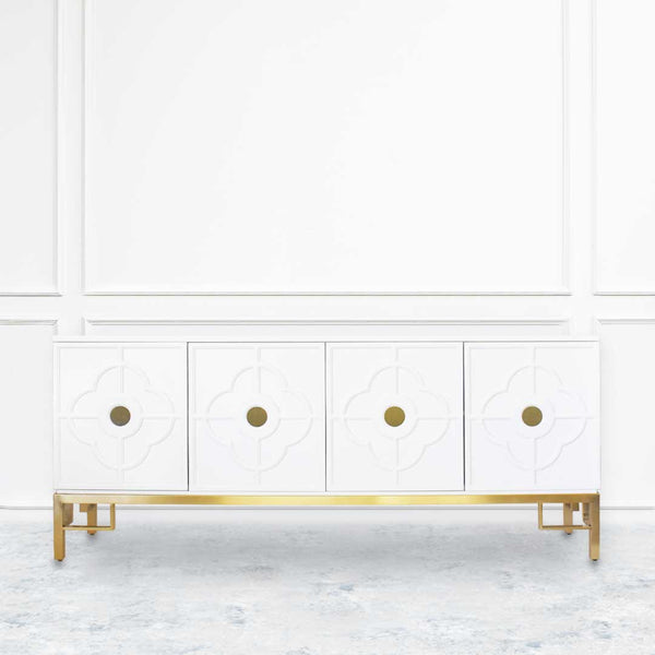 Ivory cabinet with brushed gold details on leg frame. Moroccan geometric motifs on door panels.