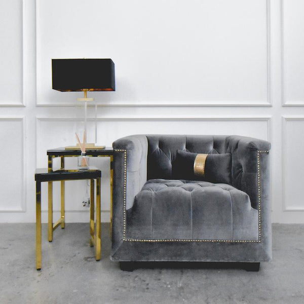 Earl Chesterfield Armchair paired with a black and gold side table and table lamp, styled in a sophisticated living room corner.
