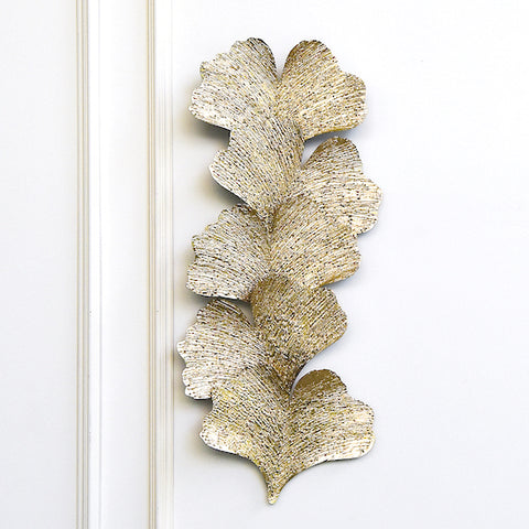 Eden Wall Art Sculpture, Gold Leaves. Create a botanical feel to your living room space with this rustic gold metal wall art featuring textured leaves sculptures. 