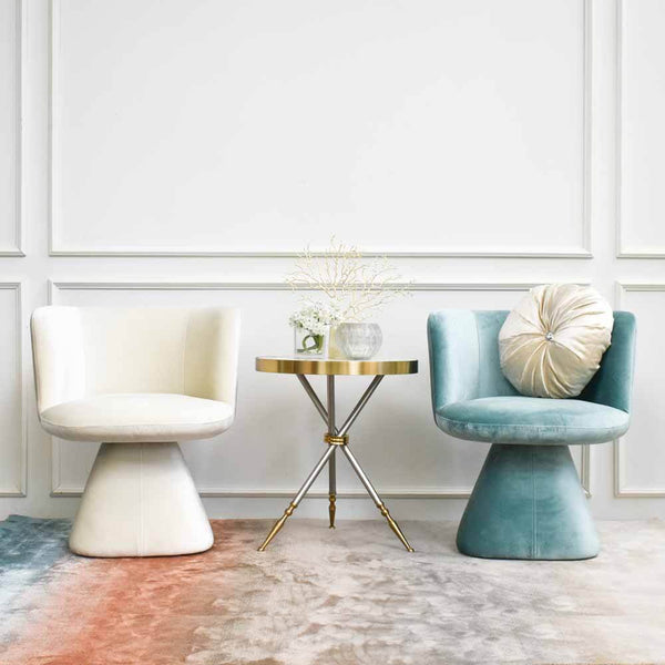 Mint and Ivory Escargpt Armchairs that swivels in living room setting, between Cristian side table and Evka sky rug.